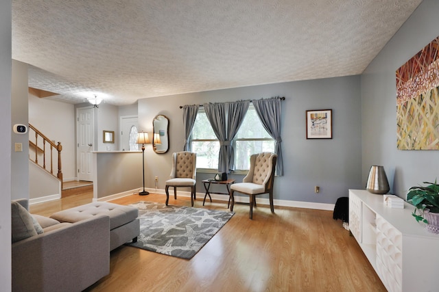 677 Fallside Ln, Westerville, OH 43081 - living area featuring a textured ceiling, wood finished floors, and stairway