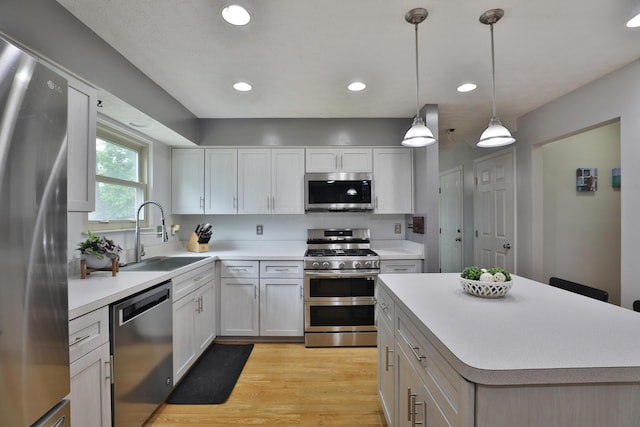 677 Fallside Ln, Westerville, OH 43081 - kitchen with stainless steel appliances, light countertops, recessed lighting, light wood-type flooring, and pendant lighting