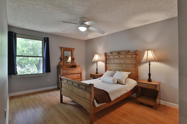 677 Fallside Ln, Westerville, OH 43081 - bedroom with light wood-style flooring, a textured ceiling, and ceiling fan