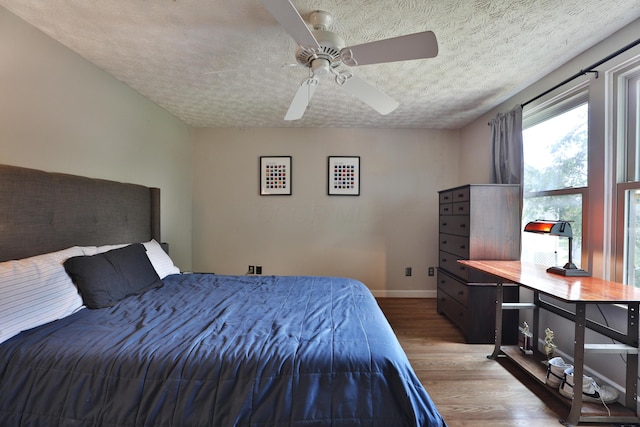 677 Fallside Ln, Westerville, OH 43081 - bedroom featuring wood finished floors, a textured ceiling, and a ceiling fan