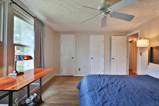 677 Fallside Ln, Westerville, OH 43081 - bedroom featuring light wood finished floors, a textured ceiling, and ceiling fan