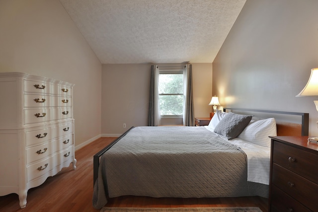 677 Fallside Ln, Westerville, OH 43081 - bedroom with vaulted ceiling, a textured ceiling, and wood finished floors