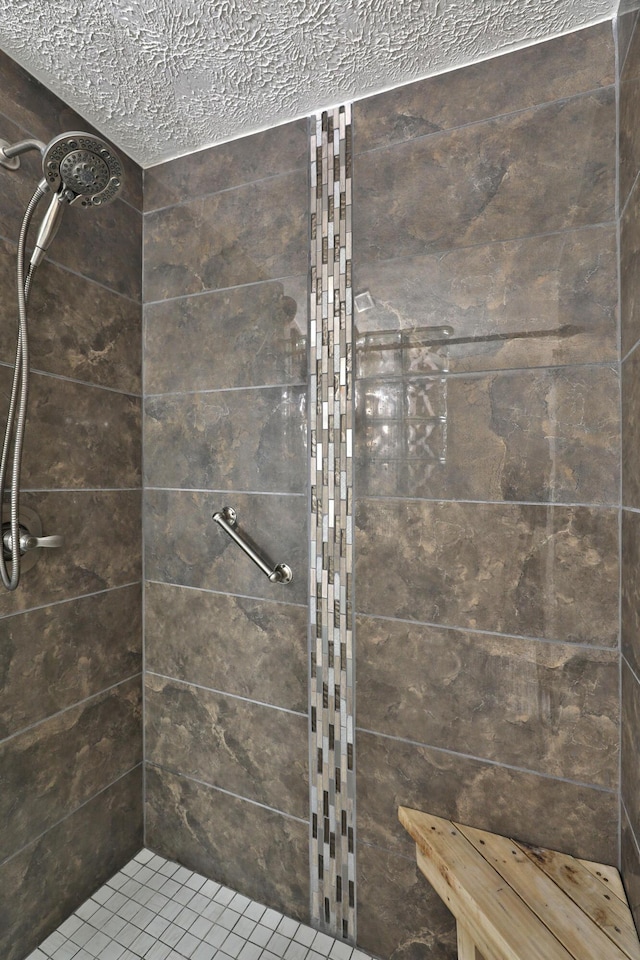 677 Fallside Ln, Westerville, OH 43081 - bathroom featuring tiled shower and a textured ceiling