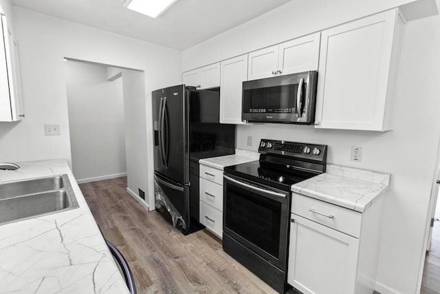 303 Rocky Fork Dr N, Columbus, OH 43230 - kitchen featuring stainless steel microwave, range with electric stovetop, fridge with ice dispenser, wood finished floors, and white cabinetry