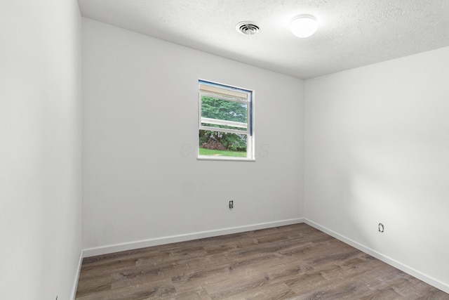 303 Rocky Fork Dr N, Columbus, OH 43230 - spare room with wood finished floors and a textured ceiling