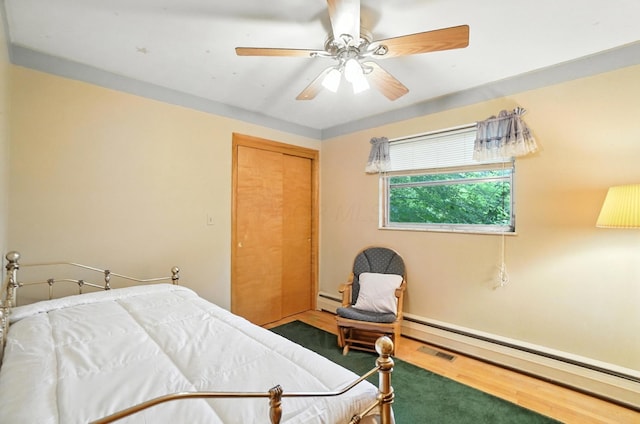 5050 Bixby Rd, Groveport, OH 43125 - carpeted bedroom with baseboard heating, a ceiling fan, a closet, and a baseboard radiator