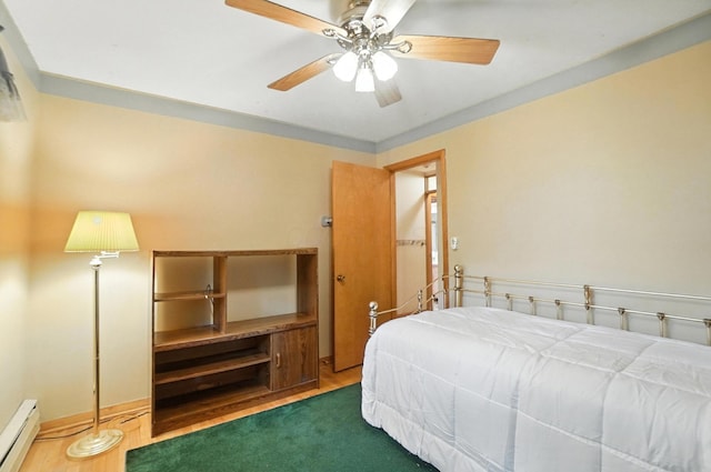5050 Bixby Rd, Groveport, OH 43125 - bedroom featuring baseboard heating, a ceiling fan, and wood finished floors