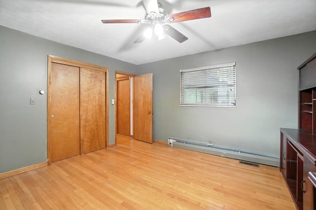 5050 Bixby Rd, Groveport, OH 43125 - unfurnished bedroom featuring baseboard heating, light wood-style flooring, a closet, and ceiling fan