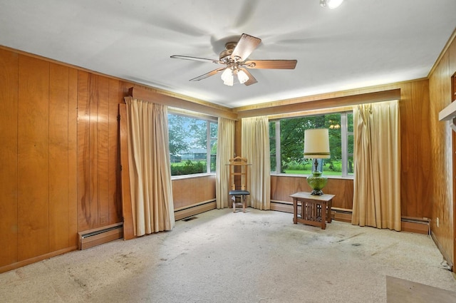 5050 Bixby Rd, Groveport, OH 43125 - carpeted spare room featuring a baseboard heating unit, a ceiling fan, and wooden walls