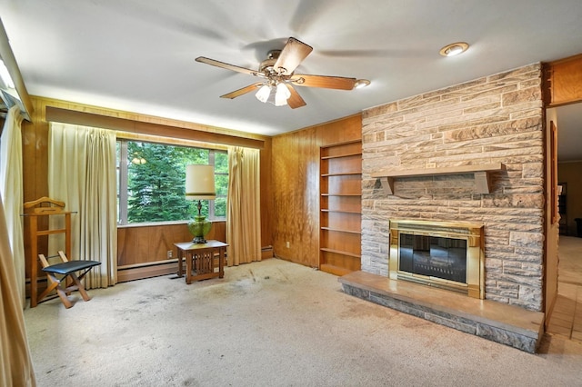 5050 Bixby Rd, Groveport, OH 43125 - unfurnished living room with ceiling fan, wooden walls, baseboard heating, carpet flooring, and built in features