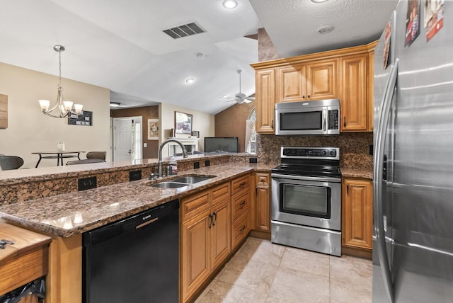 2919 Laurel Wind Blvd, Lewis Center, OH 43035 - kitchen with appliances with stainless steel finishes, a chandelier, a ceiling fan, dark stone countertops, and tasteful backsplash
