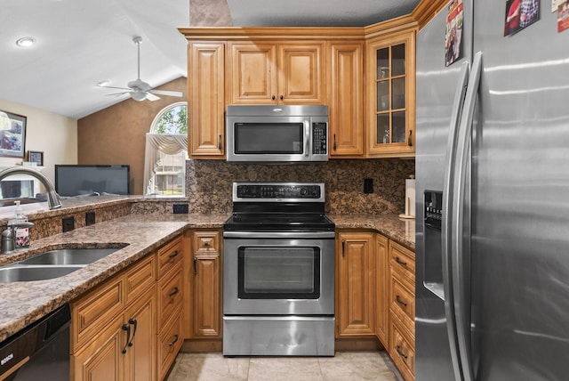 2919 Laurel Wind Blvd, Lewis Center, OH 43035 - kitchen with appliances with stainless steel finishes, vaulted ceiling, decorative backsplash, a ceiling fan, and dark stone countertops
