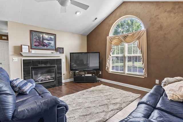 2919 Laurel Wind Blvd, Lewis Center, OH 43035 - living room with a ceiling fan, lofted ceiling, a tiled fireplace, and wood finished floors