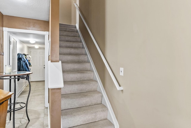 2919 Laurel Wind Blvd, Lewis Center, OH 43035 - stairway featuring tile patterned flooring and a textured ceiling