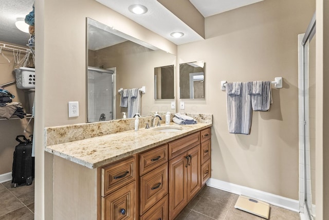 2919 Laurel Wind Blvd, Lewis Center, OH 43035 - full bathroom featuring a stall shower, a walk in closet, tile patterned flooring, and vanity
