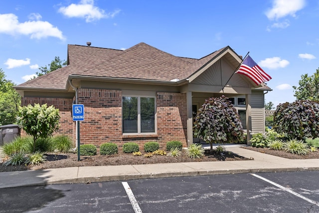 2919 Laurel Wind Blvd, Lewis Center, OH 43035 - view of front of home with brick siding, a shingled roof, and uncovered parking