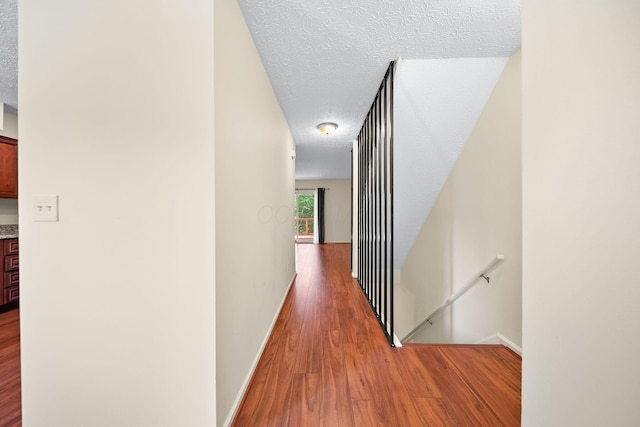 3254 Brookview Way Unit 15, Columbus, OH 43221 - hall with an upstairs landing, wood finished floors, and a textured ceiling