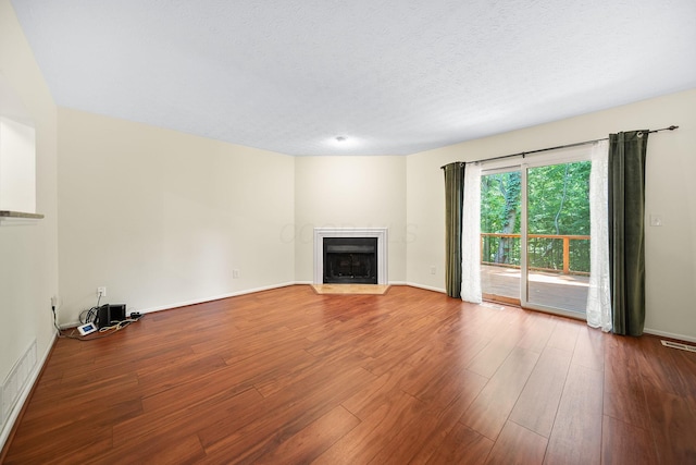 3254 Brookview Way Unit 15, Columbus, OH 43221 - unfurnished living room featuring wood finished floors, a fireplace with flush hearth, and a textured ceiling