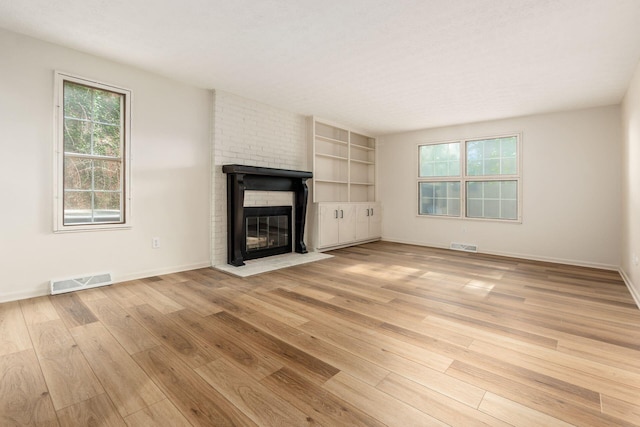 5110 Schuylkill St Unit 33-10, Columbus, OH 43220 - unfurnished living room featuring light wood-style flooring and a brick fireplace