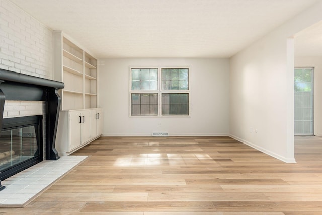 5110 Schuylkill St Unit 33-10, Columbus, OH 43220 - unfurnished living room with light wood-style flooring, built in features, and a large fireplace