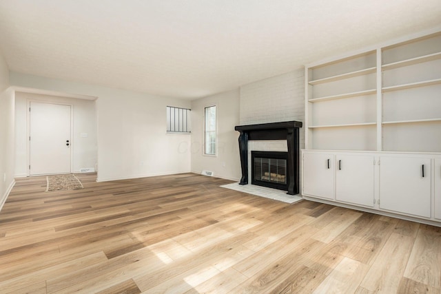 5110 Schuylkill St Unit 33-10, Columbus, OH 43220 - unfurnished living room with light wood-type flooring and a brick fireplace