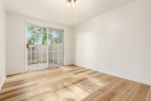 5110 Schuylkill St Unit 33-10, Columbus, OH 43220 - empty room featuring light wood-type flooring and a textured ceiling