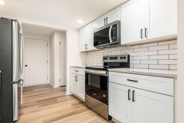 5110 Schuylkill St Unit 33-10, Columbus, OH 43220 - kitchen with stainless steel appliances, recessed lighting, white cabinetry, backsplash, and light wood-style flooring