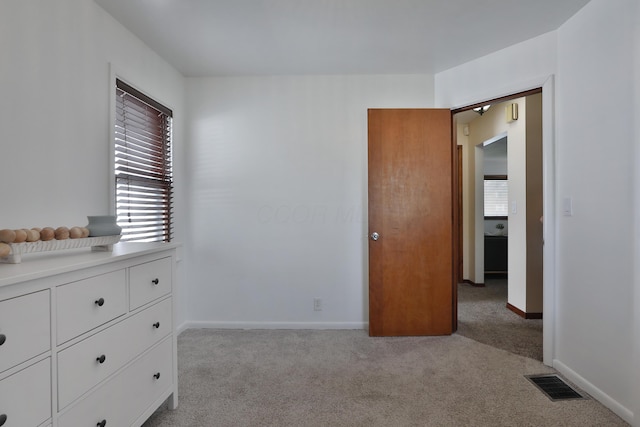 69 Morse Rd, Columbus, OH 43214 - unfurnished bedroom with light carpet and multiple windows