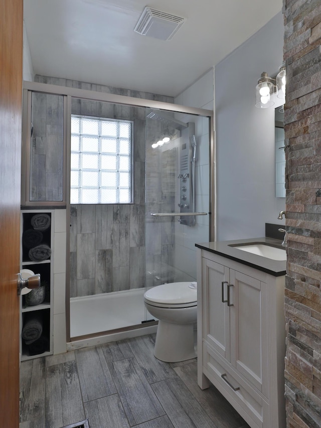 69 Morse Rd, Columbus, OH 43214 - bathroom with vanity, a shower stall, and wood finished floors