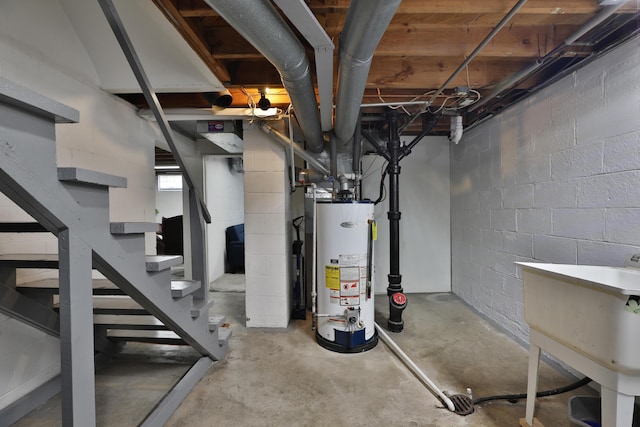 69 Morse Rd, Columbus, OH 43214 - basement with gas water heater, stairs, and concrete block wall