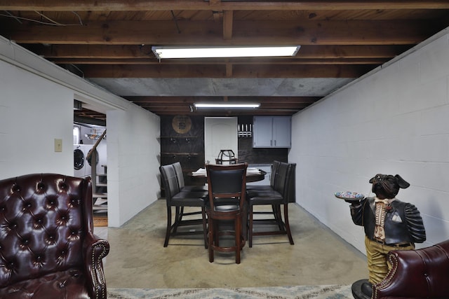 69 Morse Rd, Columbus, OH 43214 - dining space featuring concrete flooring, separate washer and dryer, and concrete block wall