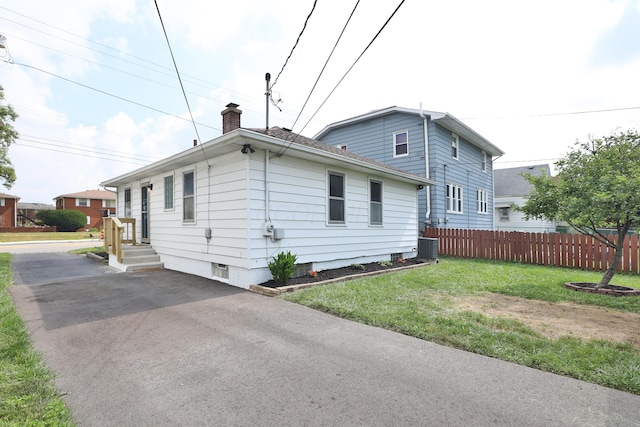 69 Morse Rd, Columbus, OH 43214 - view of side of property featuring a chimney and a cooling unit