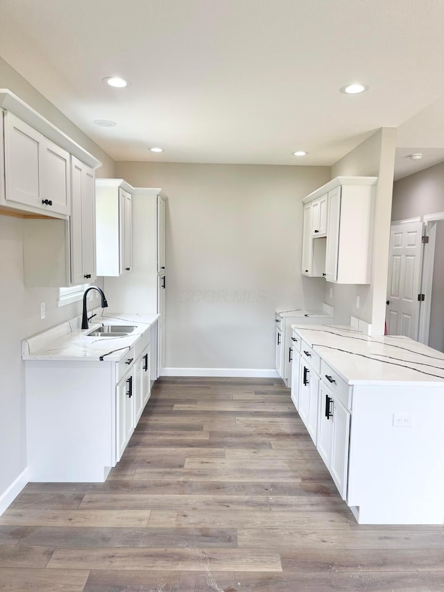 32366 Lilac Ln, Logan, OH 43138 - kitchen with light countertops, light wood-style flooring, recessed lighting, and white cabinetry