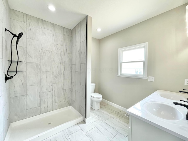 32366 Lilac Ln, Logan, OH 43138 - bathroom with marble look tiles, a tile shower, double vanity, and recessed lighting