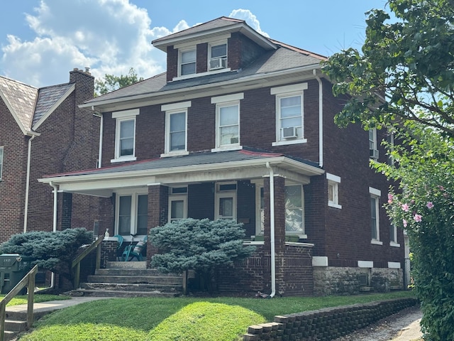 2395 Summit St, Columbus, OH 43202 - traditional style home with brick siding, a porch, and a front lawn