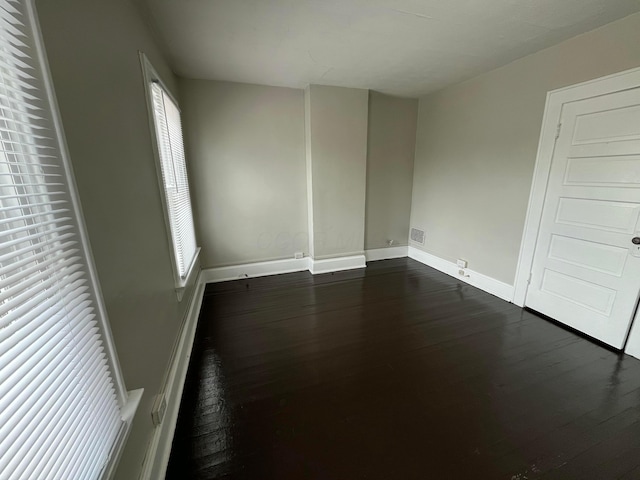 2395 Summit St, Columbus, OH 43202 - unfurnished bedroom featuring dark wood-style flooring and baseboards