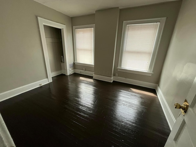 2395 Summit St, Columbus, OH 43202 - unfurnished bedroom featuring baseboards and dark wood-style flooring