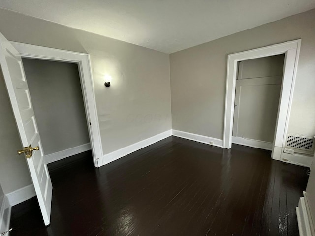 2395 Summit St, Columbus, OH 43202 - unfurnished bedroom with dark wood-style flooring and baseboards