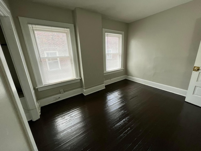 2395 Summit St, Columbus, OH 43202 - spare room featuring baseboards and dark wood-type flooring
