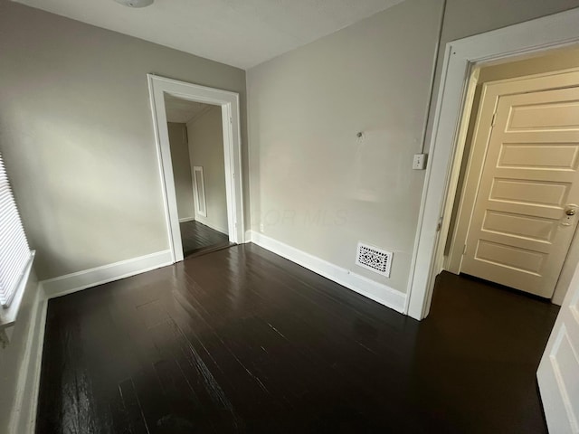 2395 Summit St, Columbus, OH 43202 - spare room with baseboards and dark wood-type flooring