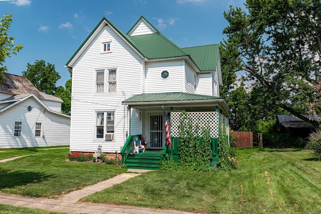 83 2nd St, Shelby, OH 44875 - view of front of property with covered porch, a front lawn, and a metal roof