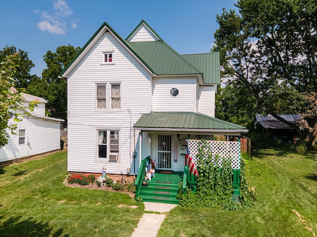 83 2nd St, Shelby, OH 44875 - view of front of property featuring a porch, a metal roof, a front lawn, and cooling unit