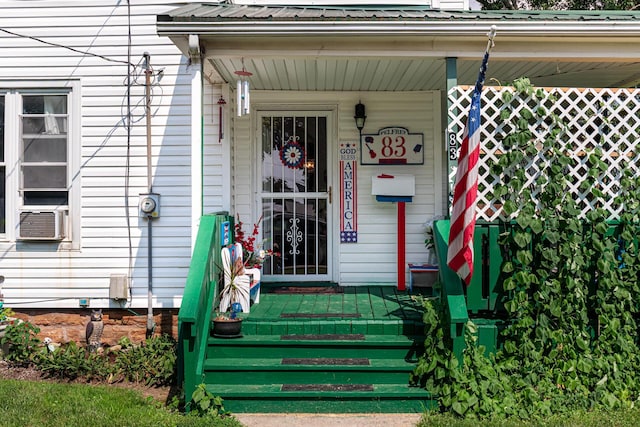 83 2nd St, Shelby, OH 44875 - property entrance featuring covered porch, a metal roof, and cooling unit