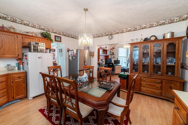 83 2nd St, Shelby, OH 44875 - dining area with a chandelier and light wood-style flooring