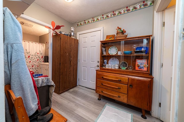 83 2nd St, Shelby, OH 44875 - bedroom with light wood-style floors and a textured ceiling