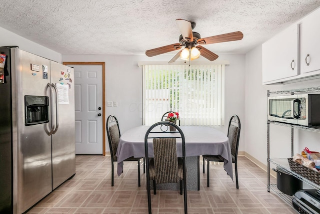 2197 Bayfield Dr, Columbus, OH 43229 - dining area with ceiling fan, a textured ceiling, and light floors