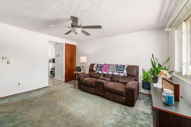 2197 Bayfield Dr, Columbus, OH 43229 - living area with a ceiling fan, light carpet, healthy amount of natural light, and a textured ceiling