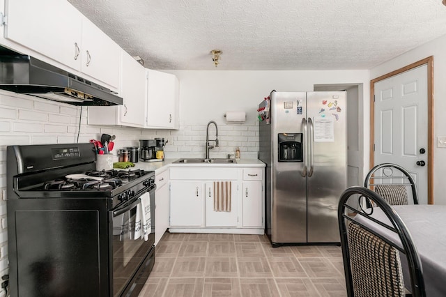 2197 Bayfield Dr, Columbus, OH 43229 - kitchen featuring black gas stove, stainless steel fridge with ice dispenser, under cabinet range hood, light countertops, and white cabinetry