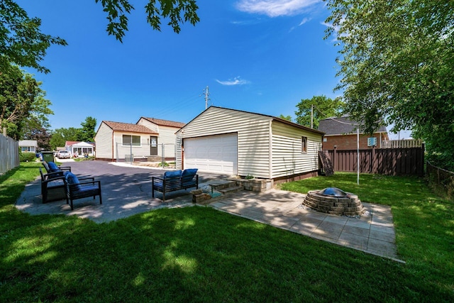 2197 Bayfield Dr, Columbus, OH 43229 - view of yard featuring a fire pit, a detached garage, and a patio