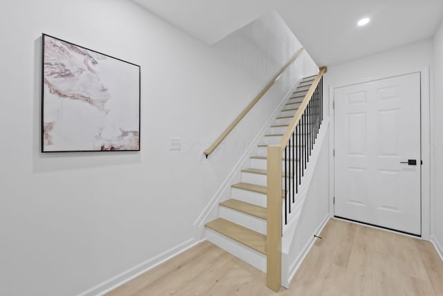583 E Walnut St, Columbus, OH 43215 - staircase with wood finished floors and recessed lighting